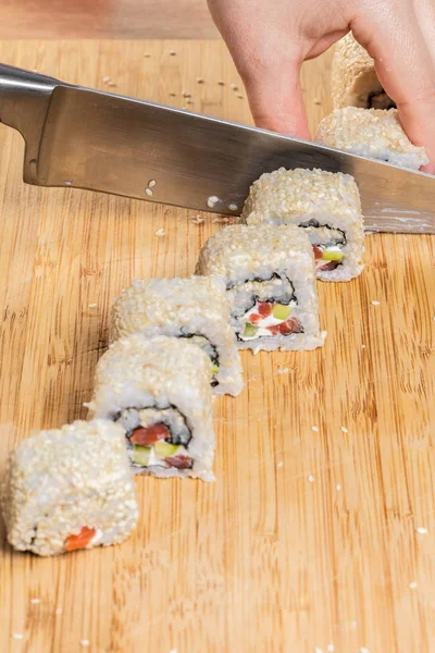 Japanese chef. Chef prepares rolls, hands closeup