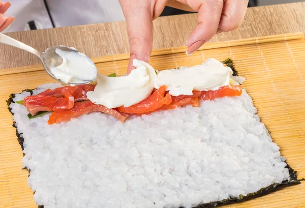 Japanese chef. Chef prepares rolls, hands closeup