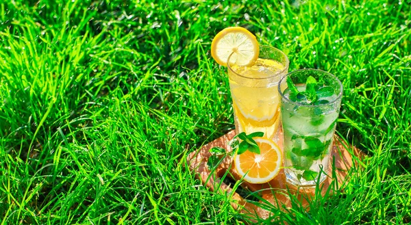 Лимонад в стакане на зеленой траве — стоковое фото