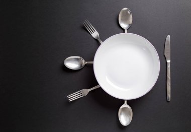 Çatal bıçak takımı siyah arka plan üzerinde beyaz plakalı. Userful gıda, Restoran Menü veya diğer için arka plan olarak