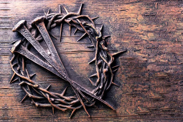 Crown of thorns and nails engraved on stone — Stock Photo, Image