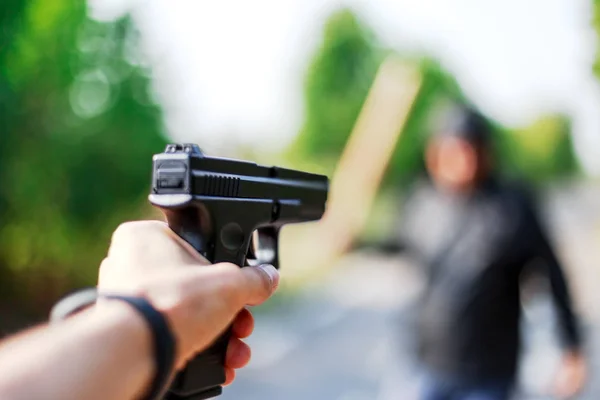 Person pointing a gun at the attacker — Stock Photo, Image
