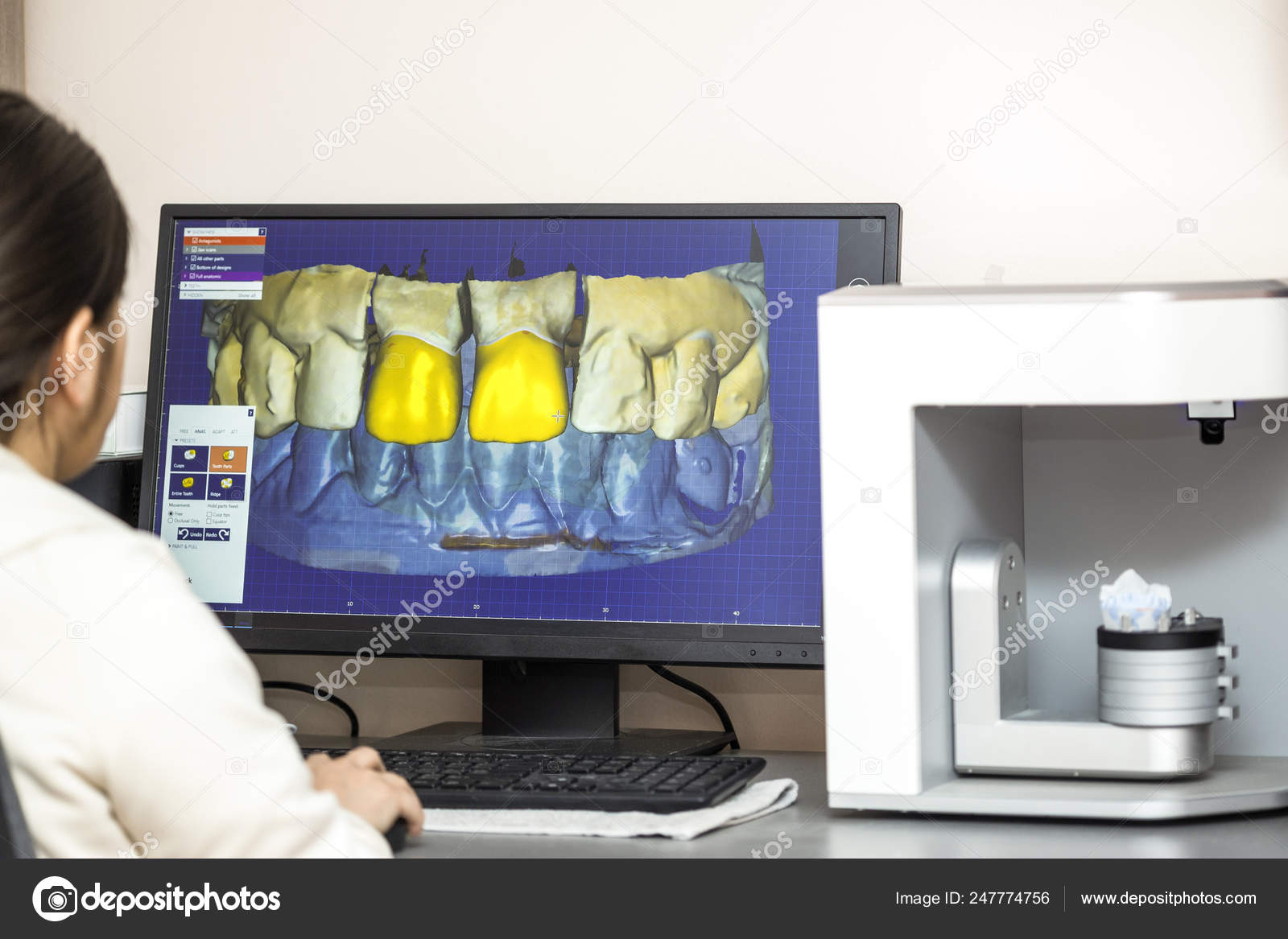 Person working on computer with dental software platform for mak Stock