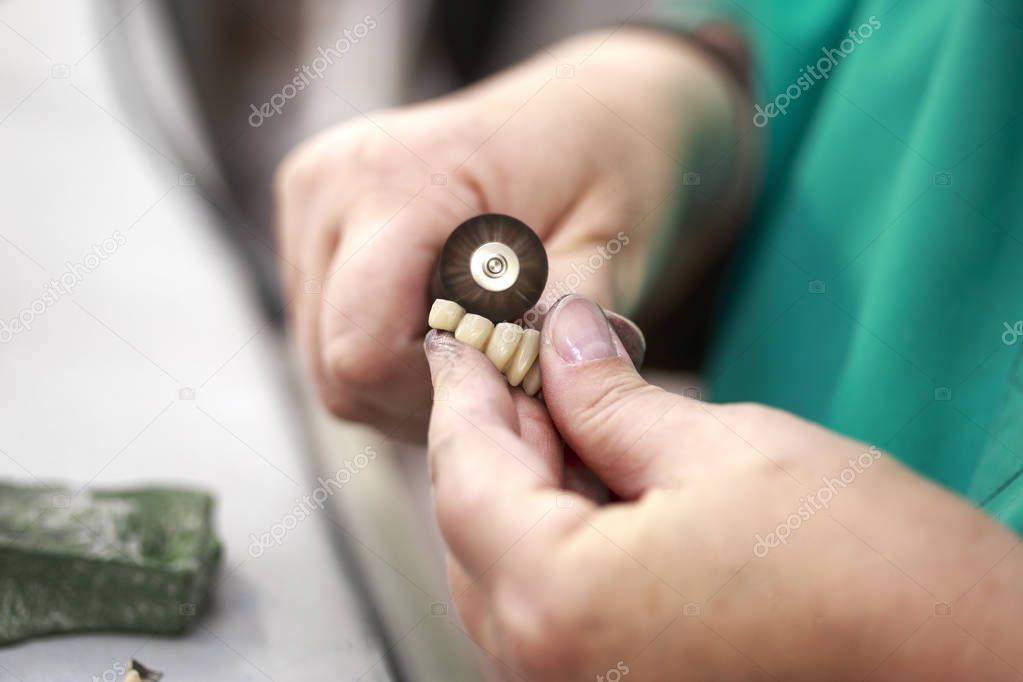 Specialist working on a metallic prosthesis.