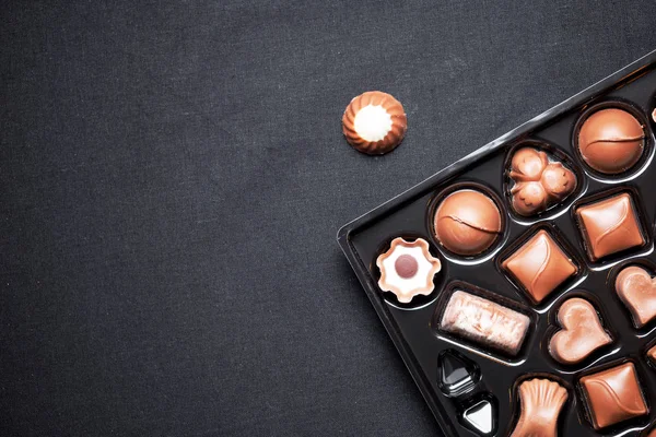 Closeup view of box of chocolates with variety chocolates pralin