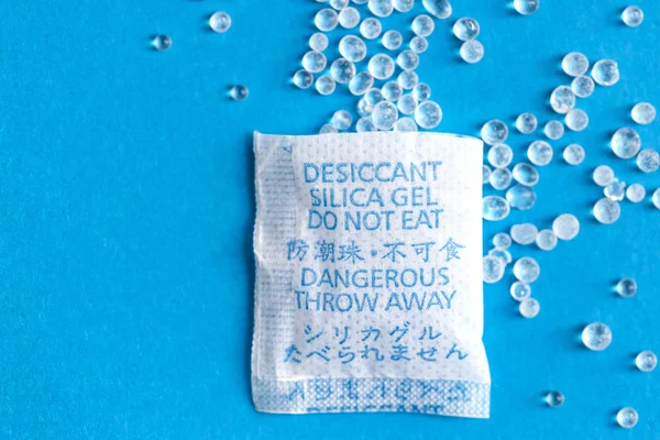 Pouch with Silica gel unfolded on blue background — Stock Photo, Image