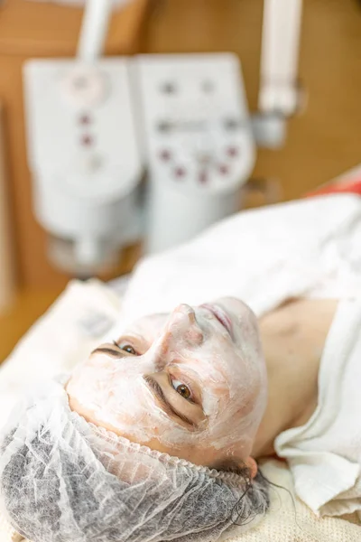 Woman with organic mask on face in spa center