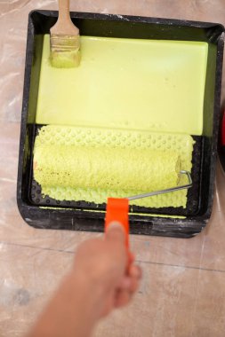 Tepside yeşil boyalı silindirli bir ressam.