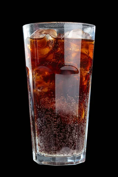 fizzy drink with ice in glass in studio, close up