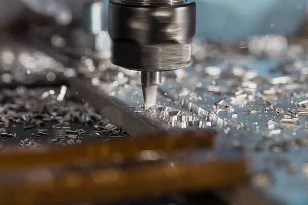 Milling of aluminum plate on a programmable machine. Milling process. Close up.