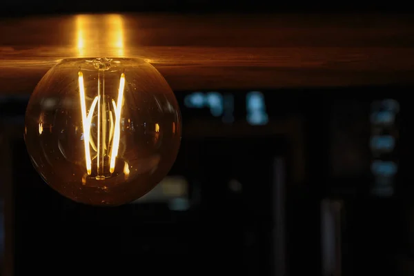 incandescent lamp retro style light illuminated the wooden surface with warm yellow-orange light