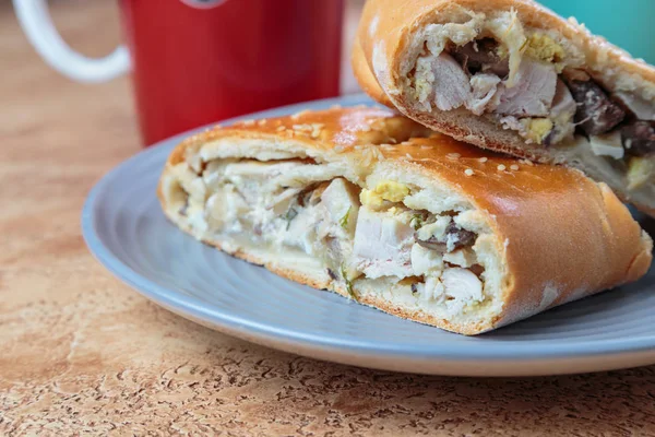 close-up shot of sliced pie stuffed with meat and vegetables on plate