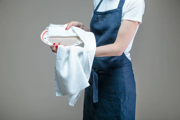 woman cleaning dish with cloth