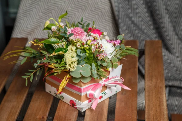 close-up shot of beautiful assorted flowers bouquet in gift box