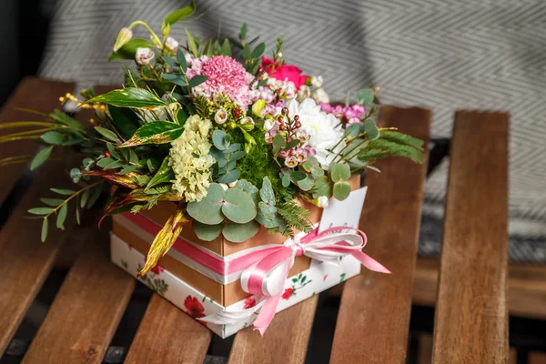 close-up shot of beautiful assorted flowers bouquet in gift box