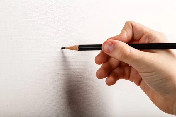 cropped shot of artist drawing on blank paper with pencil