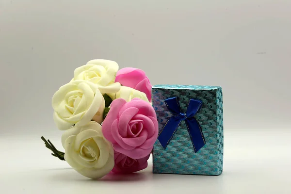 Beautiful gift bag with flowers on a white background
