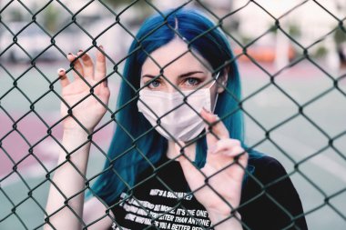 blue hair and blue eyes pale skin young girl model with cloth corona ( covid-19 ) mask street photography photoshoot clipart