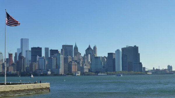 New york city skyline with blue sky and usa flag on foreground