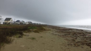 dramatik bulutlu gökyüzü altında plajda evler