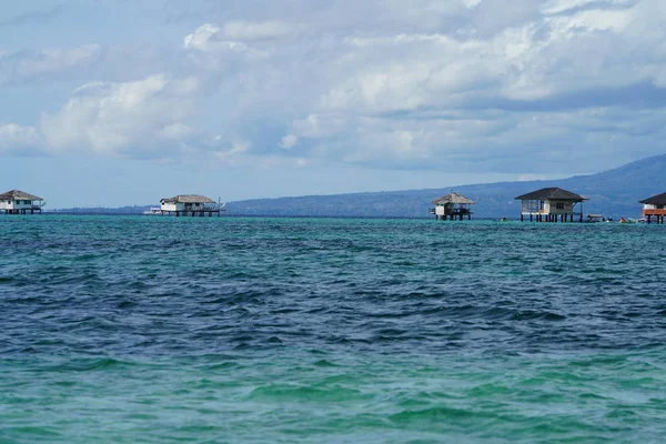 Cabañas Distantes Agua Azul Del Mar Con Montañas Fondo — Foto de Stock