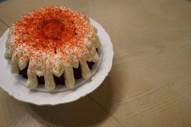 mini cake with cream and sprinkles served on plate