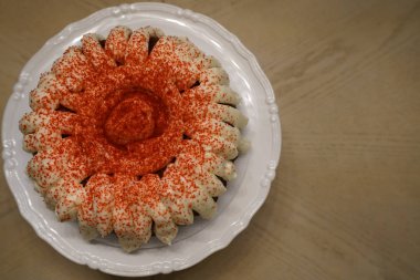 mini cake with cream and sprinkles served on plate