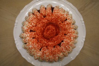 mini cake with cream and sprinkles served on plate