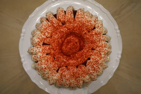 mini cake with cream and sprinkles served on plate