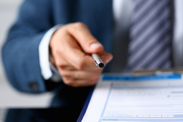 Male insurance agent hand draws a silver pen