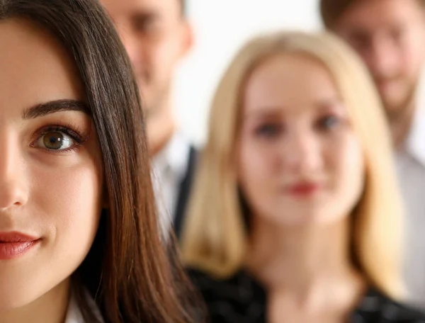 Group of smiling people stand in office looking