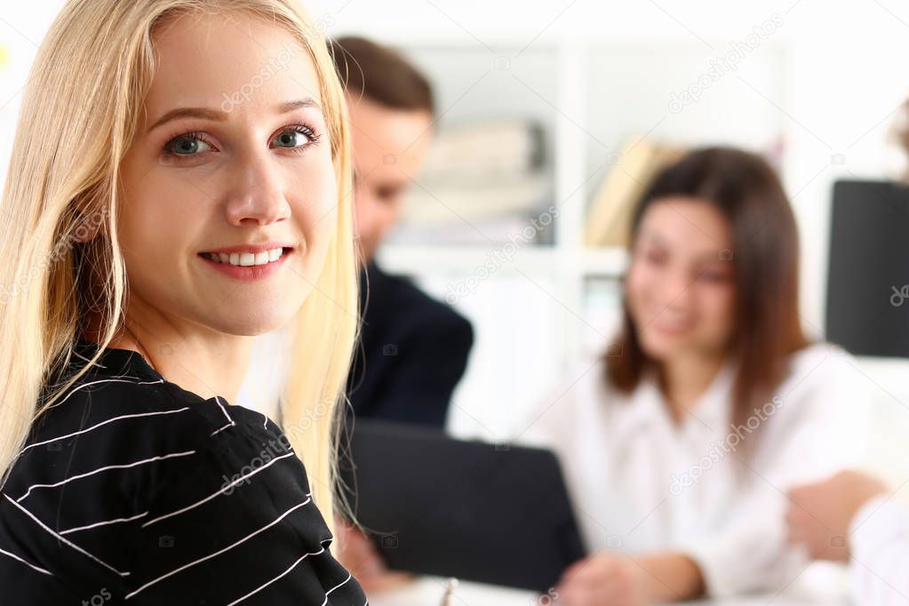 Beautiful smiling cheerful girl at workplace look in camera