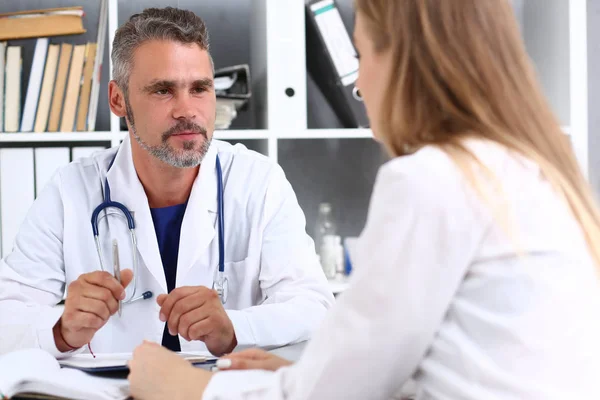 Sorridente bel medico maturo comunicare con il paziente — Foto Stock