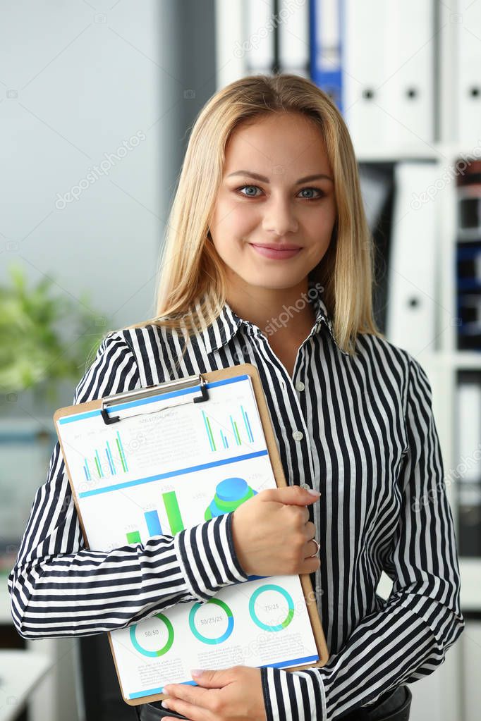 Businesswoman hold clipboard with business chart
