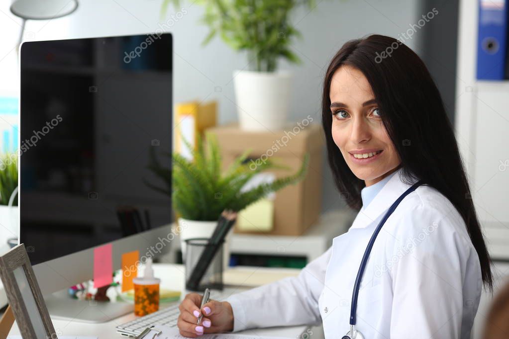 Latina female doctor portrait aganist hospital