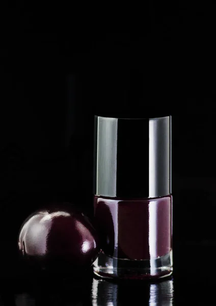 Natural nail polish silver color and plum on black background