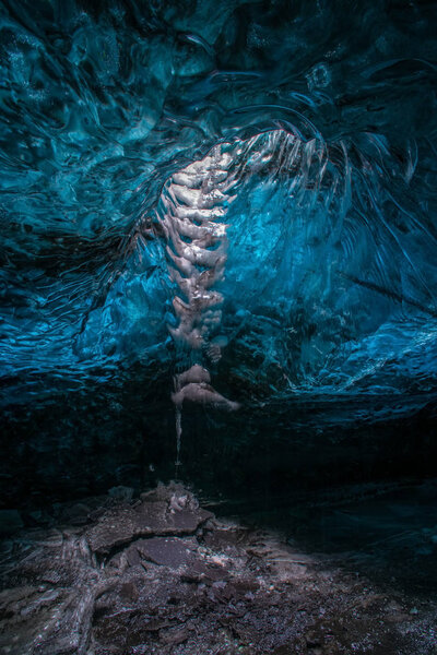 Ice Caves or Crystal Caves in Icelandic glaciers are a truly mesmerizing wonder of nature. The blue-glazed glacier blows away and creates amazing caves. Running water and black sand.