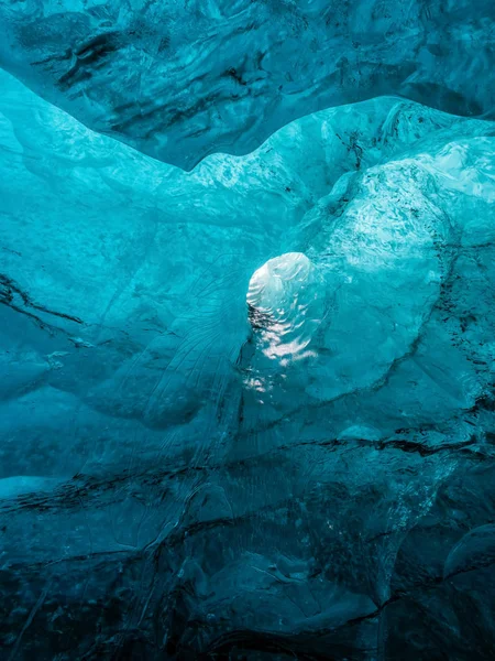 Ice Caves or Crystal Caves in Icelandic glaciers are a truly mesmerizing wonder of nature. The blue-glazed glacier blows away and creates amazing caves. Running water and black sand.