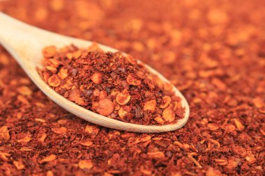 Kırmızı arkaplanda kırmızı biber kaşığı