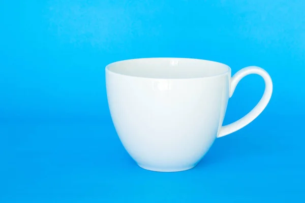 white mug cup on blue background