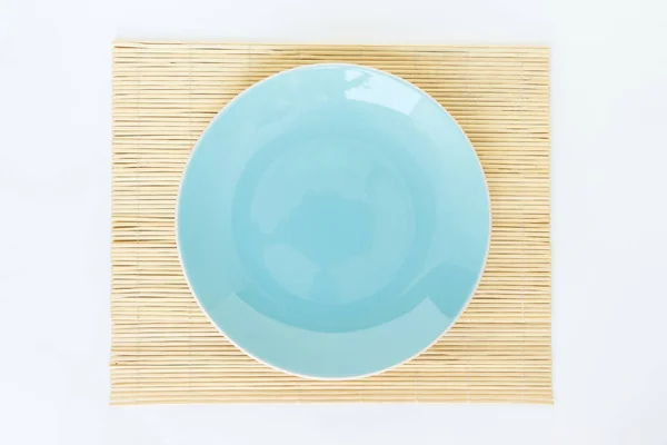 blue plate empty and bamboo, mat on white background