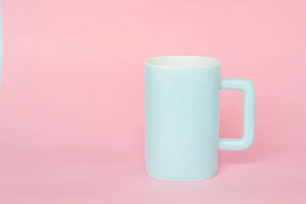 blue mug on a pink background