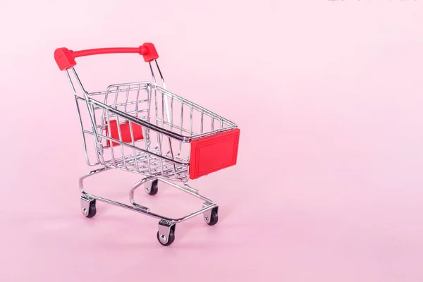 Carrito Compras Rojo Sobre Fondo Rosa —  Fotos de Stock