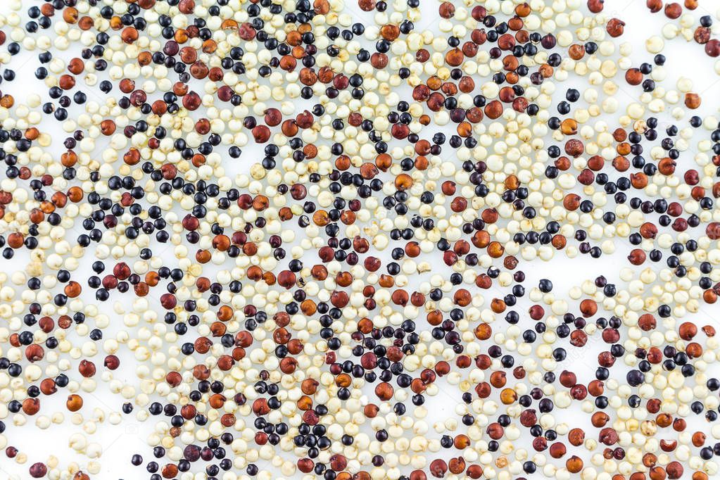 pile quinoa on white background.