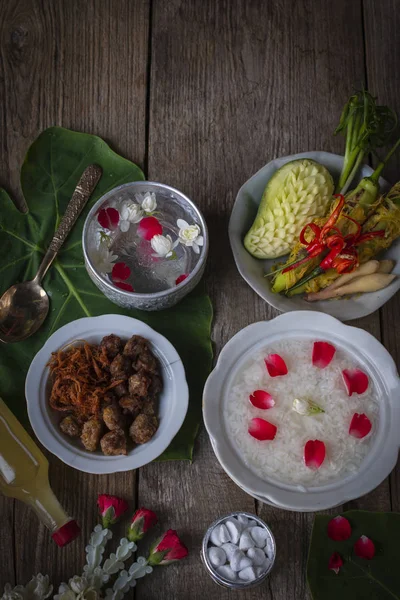 Khao-Chae, Cooked Rice Soaked in Iced Water in the white bowl and Eaten with the Usual Complementary Food and to decorate by flower, scented water.