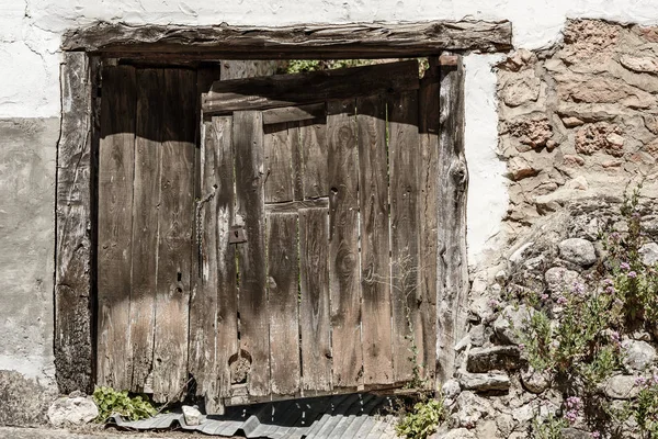 Wooden door of an old rustic house — Stock Photo, Image