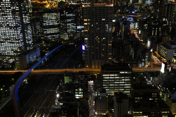 Tokyo city skyline and railway with night light , cityscape , skyscraper Japan