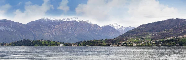 Bellagio villa in Como lake Italy with snow and mountain looking from boat in Lenno side