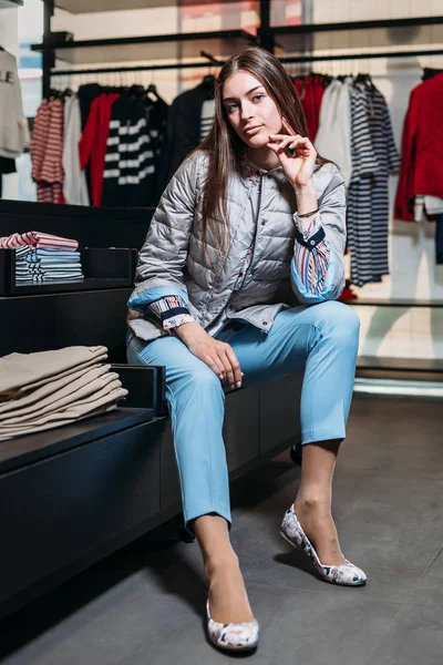 shopping, fashion, style, sale, shopping, business and people. concept beautiful happy young woman in a clothing store. the business owner is a clothing store. businesswoman