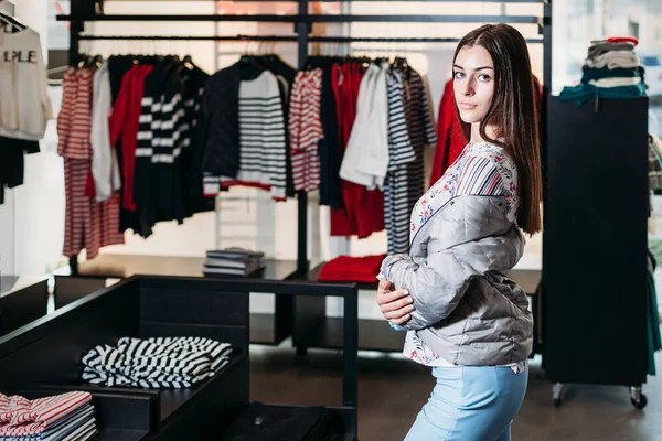 shopping, fashion, style, sale, shopping, business and people. concept beautiful happy young woman in a clothing store. the business owner is a clothing store. businesswoman